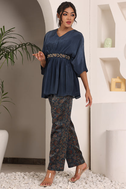 Blue pleated top with ajrakh pants and belt