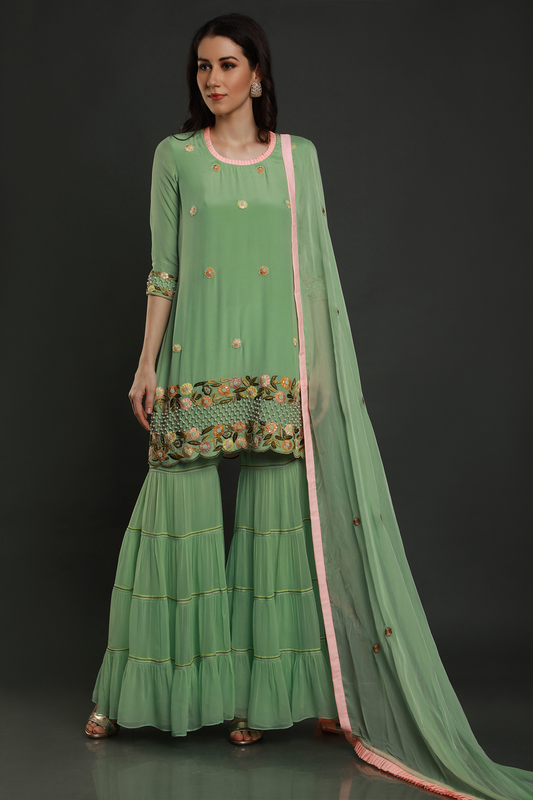 "Stunning mint green crepe kurta with intricate threadwork, pearl beads & cutdana, paired with layered garara & shaded dupatta - A mesmerizing ensemble!"