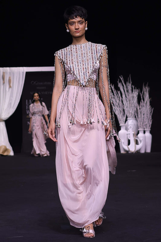 Peachy Pink ajrakh stripwork jacket paired up with Peachy pink bralette and drape dhoti skirt