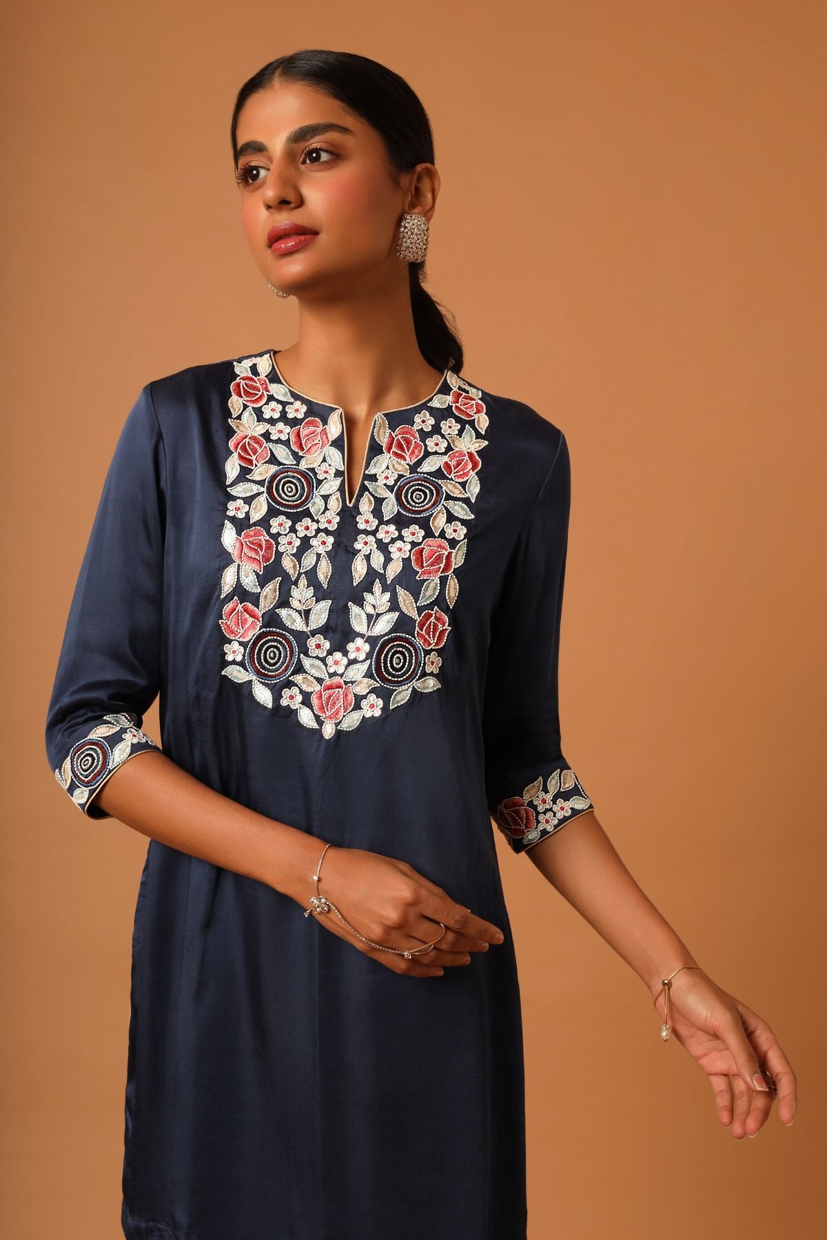 "Elevate your style with our finely handcrafted short kurti paired up with trendy asymmetrical pants. Perfect for a chic and unique look. Shop now!"