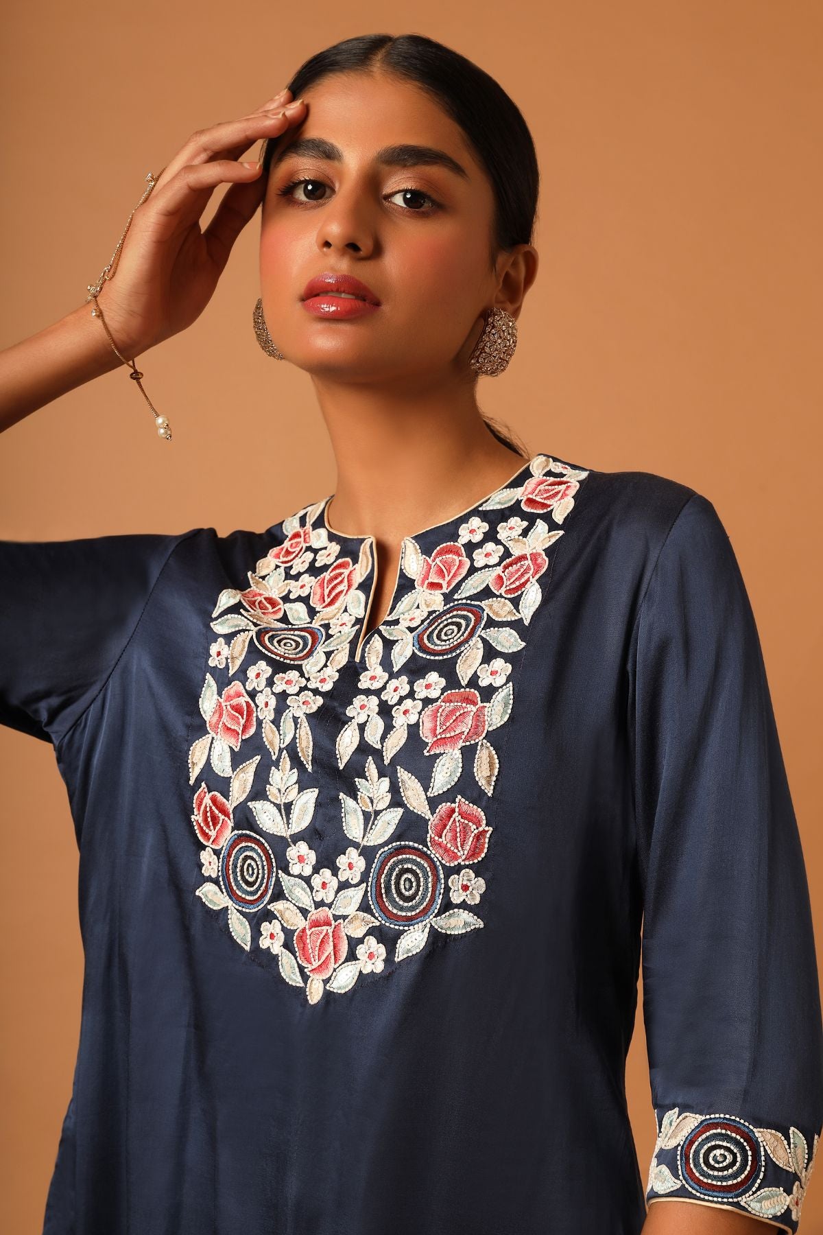 "Elevate your style with our finely handcrafted short kurti paired up with trendy asymmetrical pants. Perfect for a chic and unique look. Shop now!"