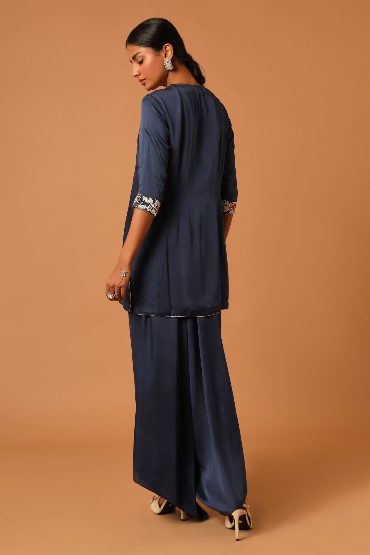 "Elevate your style with our finely handcrafted short kurti paired up with trendy asymmetrical pants. Perfect for a chic and unique look. Shop now!"
