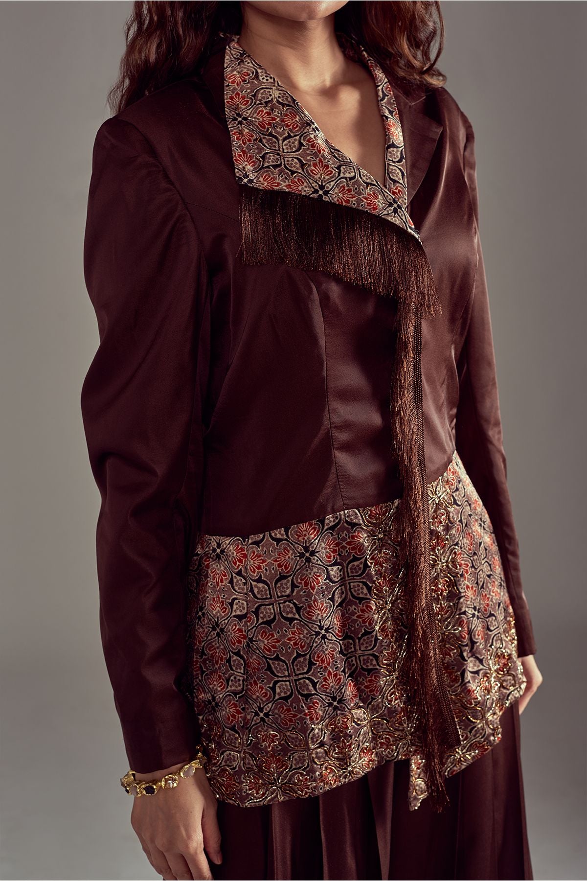 Step into elegance with a Peplum Chocolate Brown Blazer in Pure Mashru Silk, adorned with Ajrakh work. Perfectly paired with Chocolate Brown Pants in Mashru Silk