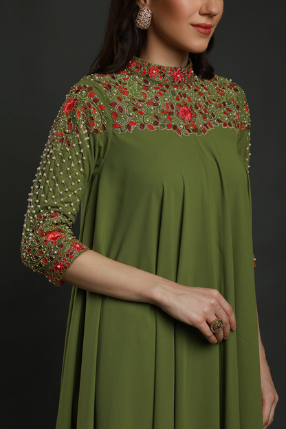 Elevate your elegance in a Mehendi Green Moss Crepe asymmetric maxi dress. Hand-embroidered with thread, pearls, and cut dana work for a unique flair.