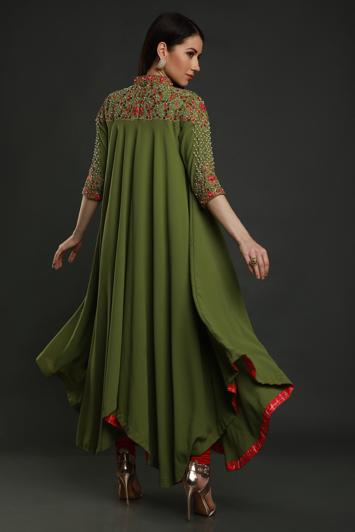 Elevate your elegance in a Mehendi Green Moss Crepe asymmetric maxi dress. Hand-embroidered with thread, pearls, and cut dana work for a unique flair.