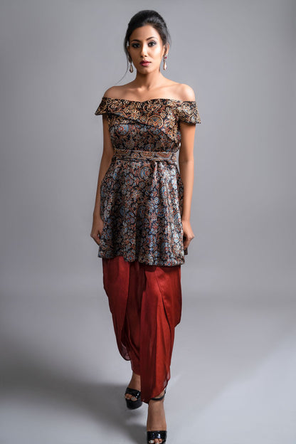 "Elegant Ajrakh Off-Shoulder Peplum Top in Pure Modal Silk with Intricate Hand Embroidery, perfectly paired with Maroon Pleated Dhoti in Pure Crepe."