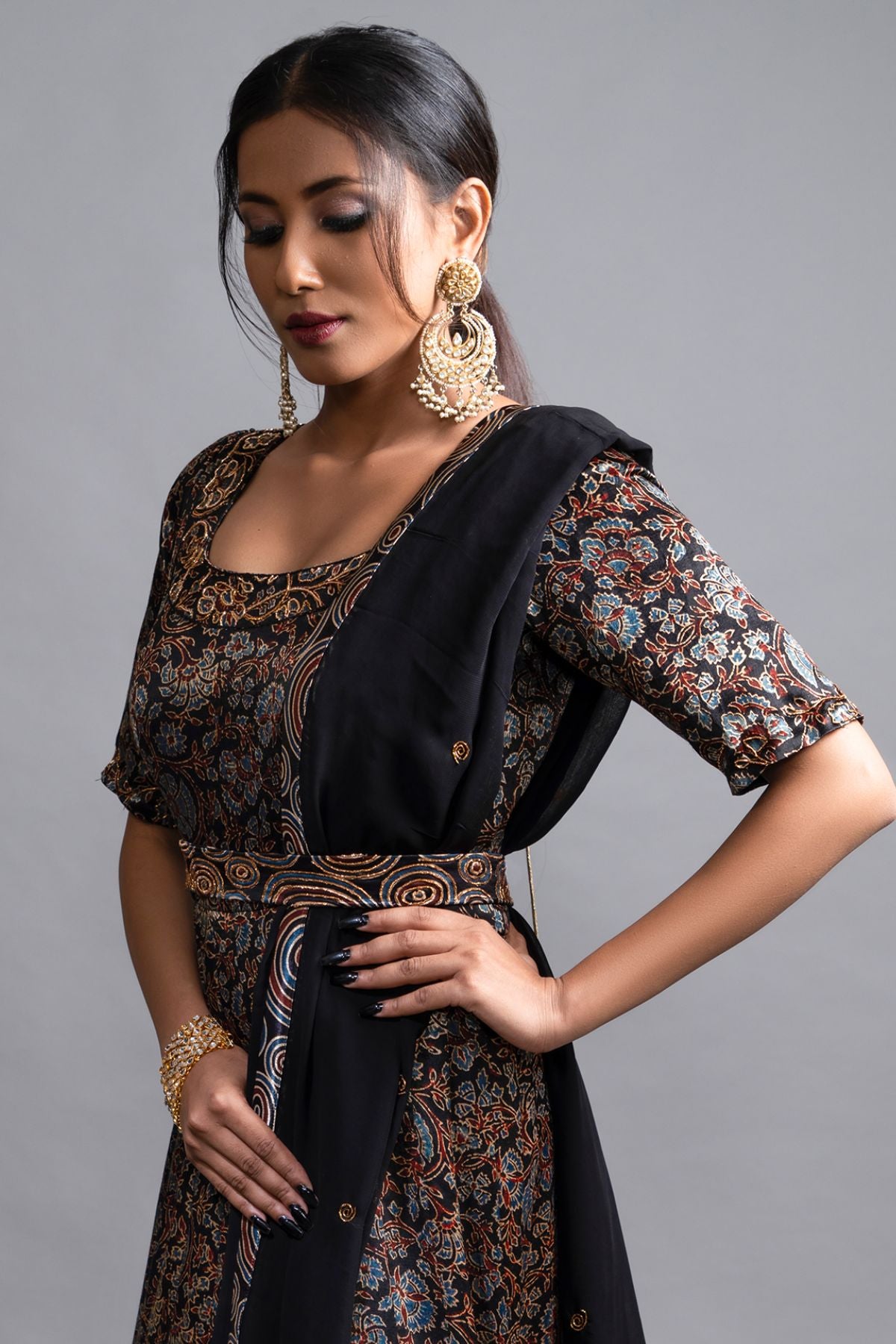 "Stunning Anarkali in Pure Mashru Silk Ajrak Print, featuring an Organza Dupatta. Exquisite Nakshi and Zardosi Embroidery adorn the Panel and Yoke."