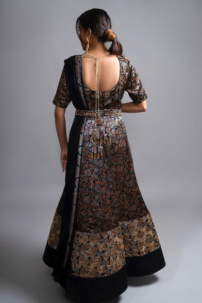 "Stunning Anarkali in Pure Mashru Silk Ajrak Print, featuring an Organza Dupatta. Exquisite Nakshi and Zardosi Embroidery adorn the Panel and Yoke."