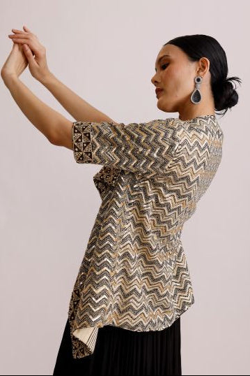 Woman wearing a patterned dress with a plain background