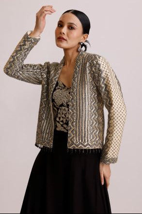 Woman wearing a patterned outfit against a neutral background