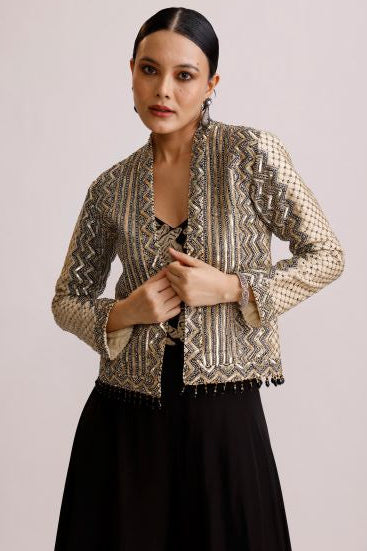 Person wearing a patterned outfit with a plain background