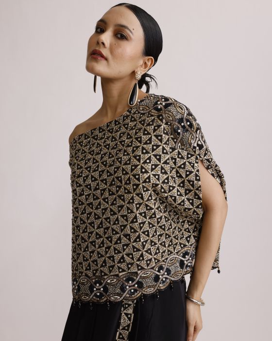 Woman wearing a patterned top with a plain background