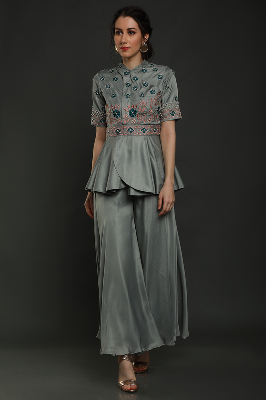 Discover elegance in our Dark Clay Grey satin crepe peplum jumpsuit, adorned with exquisite hand embroidery. Convertible into a top and bottom set.
